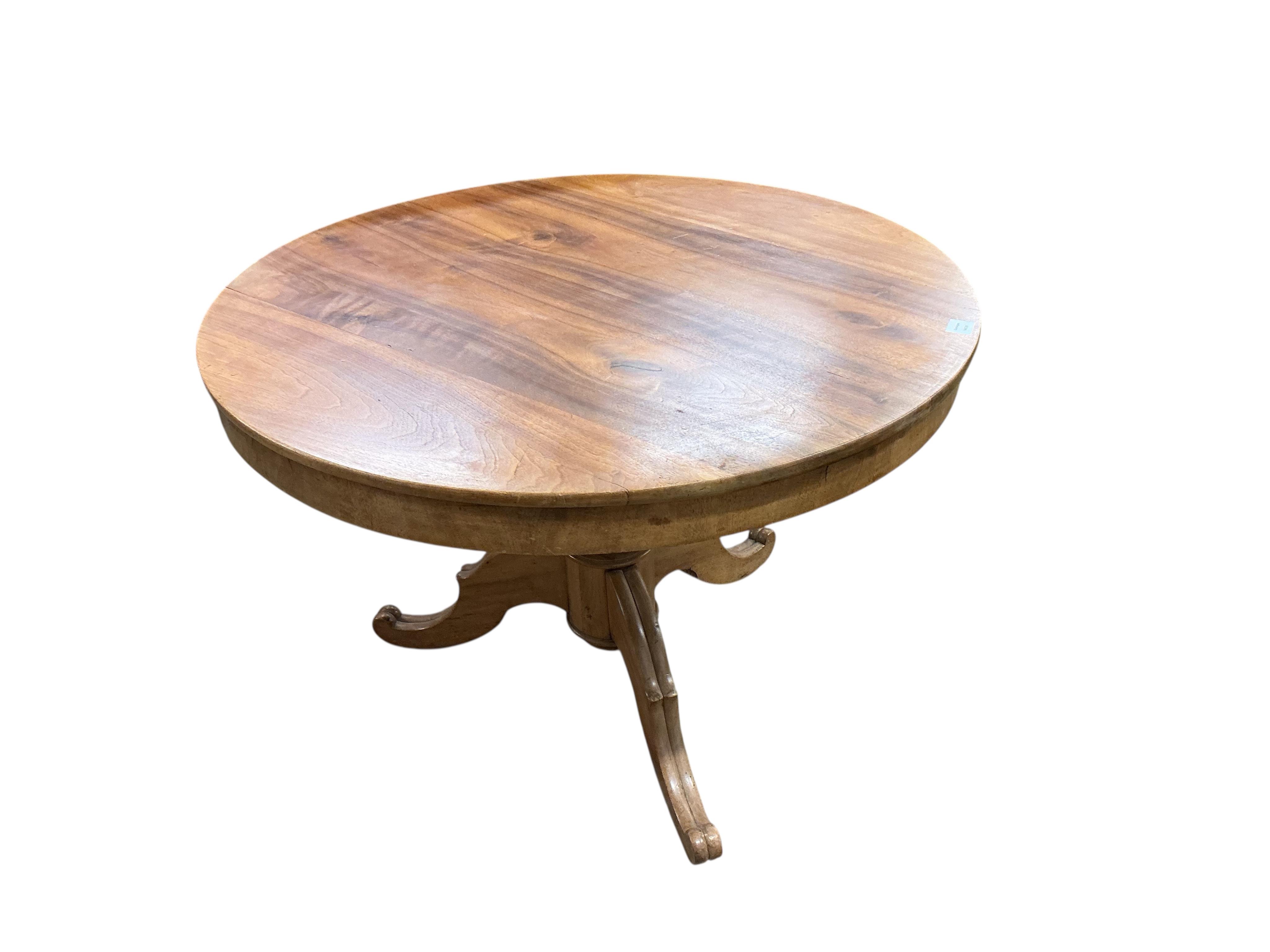 A Swedish circular walnut breakfast table, diameter 107cm, height 76cm together with four dining chairs, one with arms